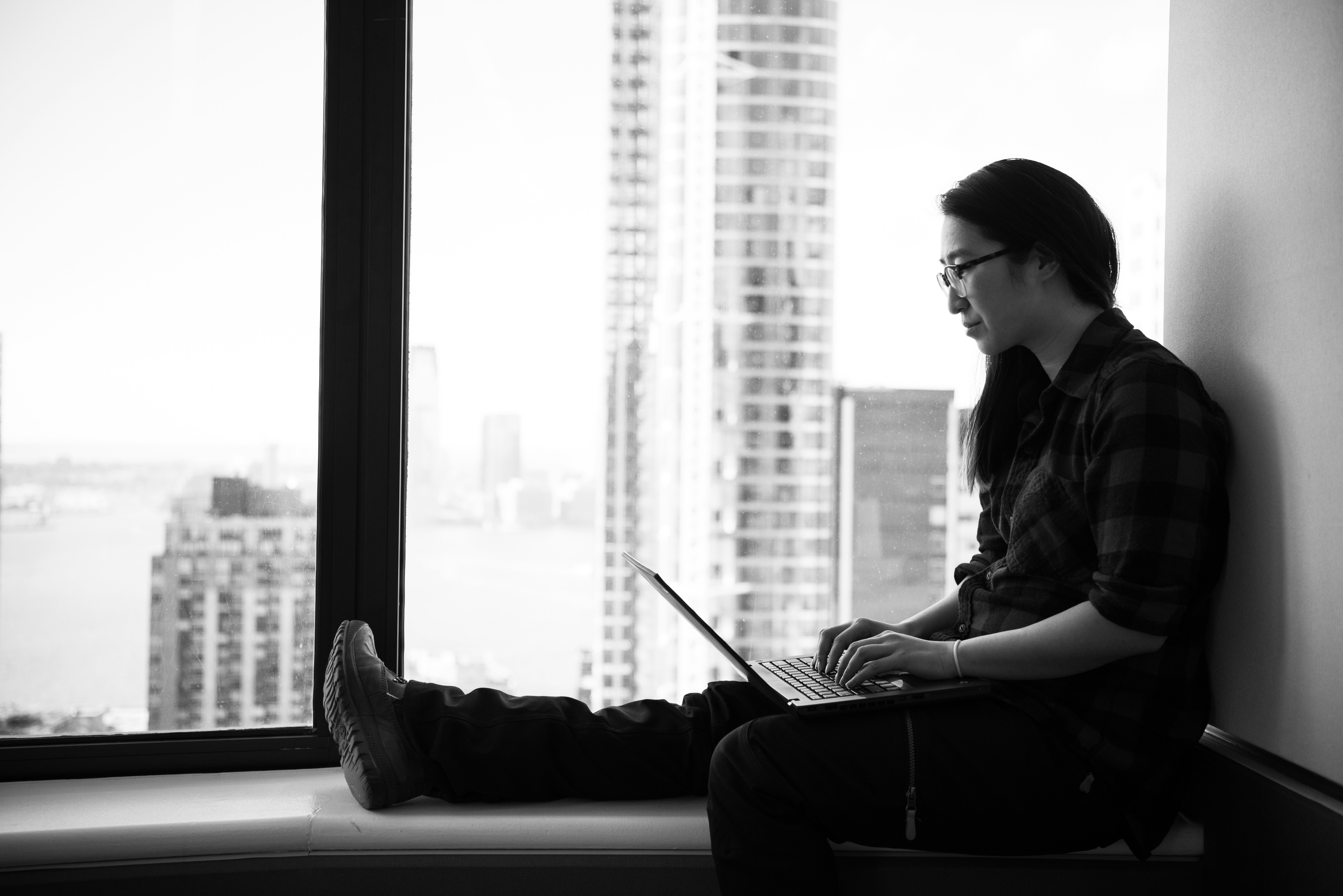woman by the window working - Best Use Cases for ChatGPT