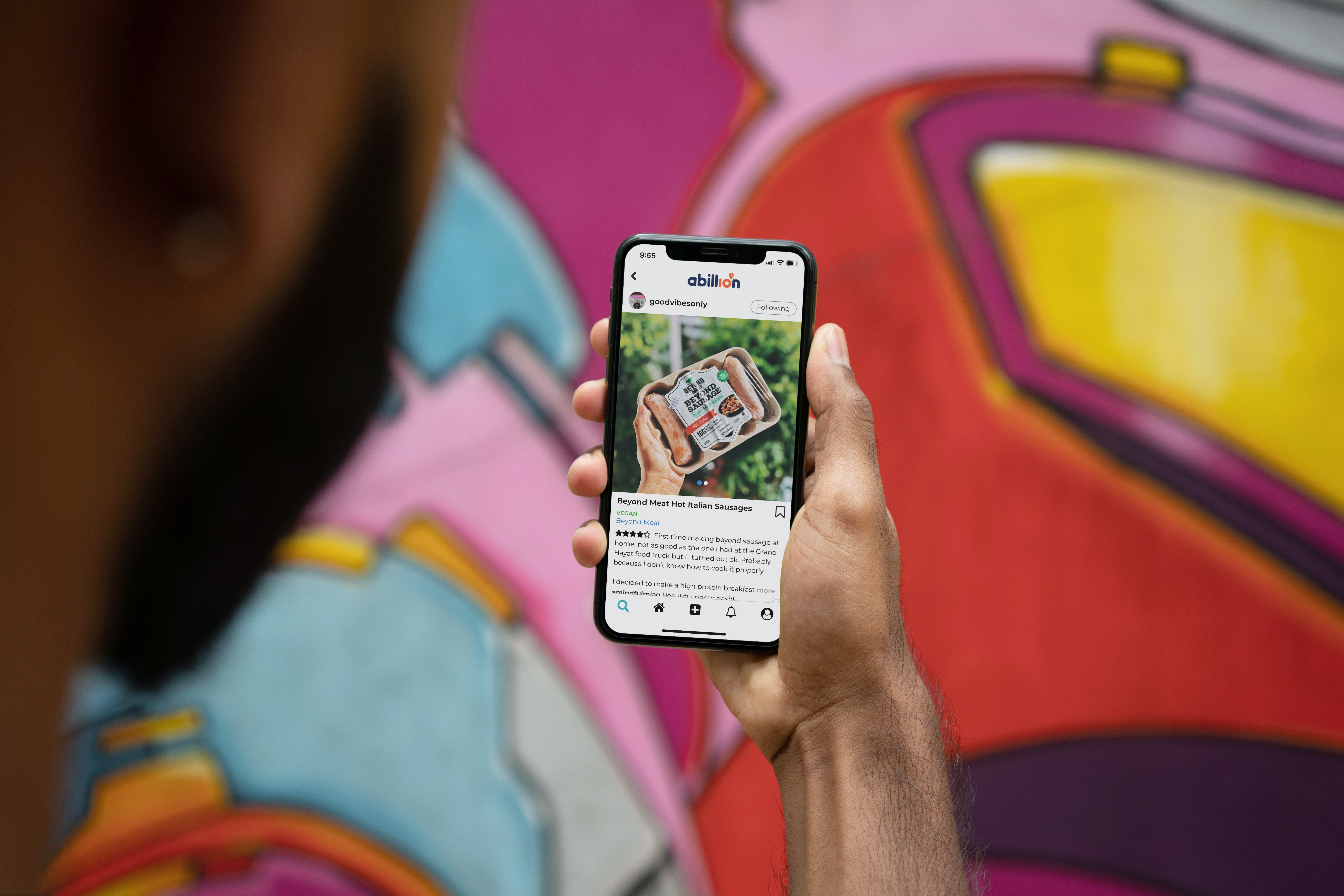person looking at feedback on mobile - voice of customer sentiment analysis